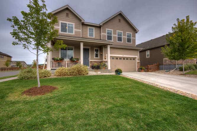 Front of tan colored house with yard in Erie Colorado